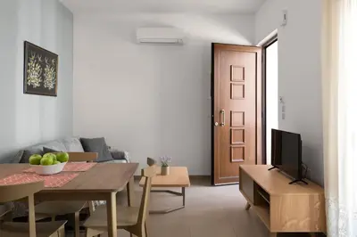a living room with a table and a couch at gefiraki apartment in Koskinou
