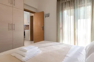 a bedroom with a bed with towels on it at gefiraki apartment in Koskinou