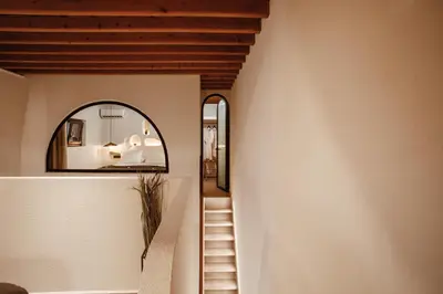 a staircase in a house with a mirror at Noema Lindos - Athena Apartment in Líndos