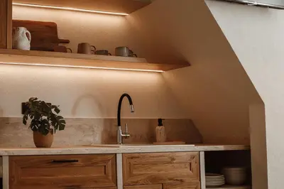 a kitchen with a sink and a counter with a shelf at Noema Lindos - Athena Apartment in Líndos