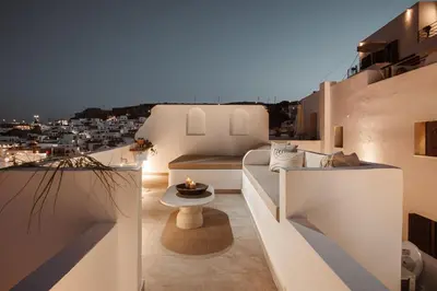 a balcony with a view of a city at night at Noema Lindos - Athena Apartment in Líndos