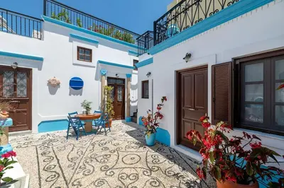 a courtyard of a house with a table and chairs at Genovefa traditional house in Koskinou