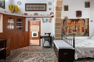 a bedroom with a bed and a table in it at Genovefa traditional house in Koskinou