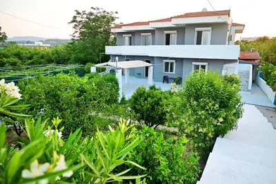 a view of a house from the garden at Karmik Concept Apartments in Afantou