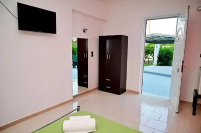 a living room with a flat screen tv on the wall at Karmik Concept Apartments in Afantou