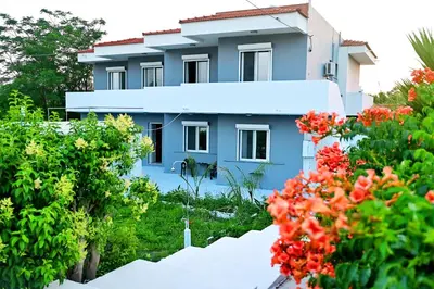 a building with flowers in front of it at Karmik Concept Apartments in Afantou