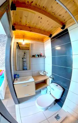 a bathroom with a toilet and a sink at Beach Studio - Sleeps 2 & Private Ocean Terrace in Haraki