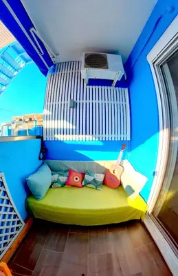 a small room with a green couch in a room at Beach Studio - Sleeps 2 & Private Ocean Terrace in Haraki
