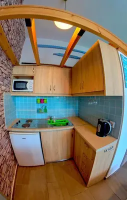 a small kitchen with a sink and a microwave at Beach Studio - Sleeps 2 & Private Ocean Terrace in Haraki