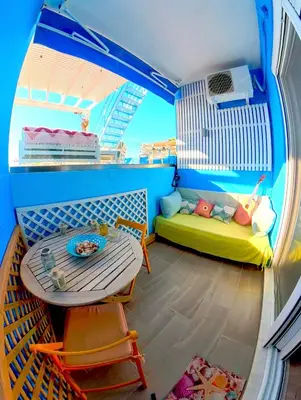 a small room with a table and a couch at Beach Studio - Sleeps 2 & Private Ocean Terrace in Haraki