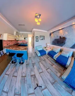 a living room with a large painting on the wall at Deluxe Beach Apartment- Sleeps 2 & Private Terrace in Haraki