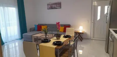a living room with a table and a couch at A&J Apartments in Gennadi