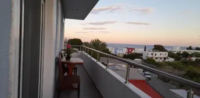 a balcony with a table and a view of the city at A&J Apartments in Gennadi