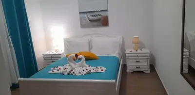 a bedroom with a bed with two towels on it at A&J Apartments in Gennadi