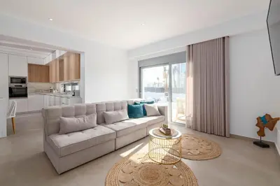 a living room with a couch and a table at Martini Villas in Kremasti