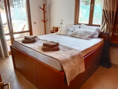 a bedroom with a large bed with towels on it at Tsampika's Traditional Stone Cottage in Siana in Siána