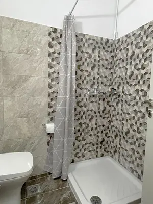 a bathroom with a shower and a white toilet at Rhodes Central: King Bed Studio in Rhodes Town