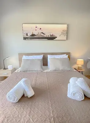 a bedroom with a bed with two towels on it at Rhodes Central: King Bed Studio in Rhodes Town