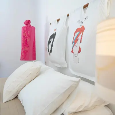 a bed with white pillows in a room at Villa Ixia in Ialyssos