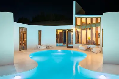 a swimming pool in the middle of a house at night at Villa Ixia in Ialyssos