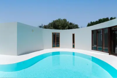 a white house with a swimming pool at Villa Ixia in Ialyssos