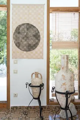 two vases on display in a room with a window at Villa Ixia in Ialyssos