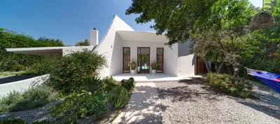 a white house with a tree in front of it at Villa Ixia in Ialyssos
