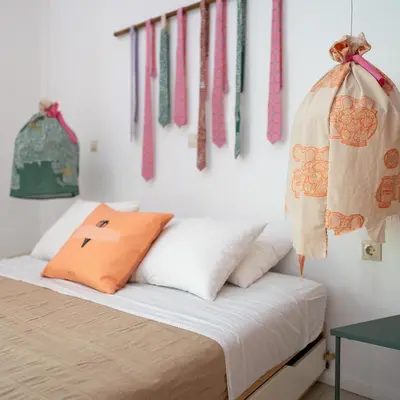 a bedroom with a bed with ties hanging on the wall at Villa Ixia in Ialyssos
