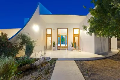a white house with a blue roof at Villa Ixia in Ialyssos