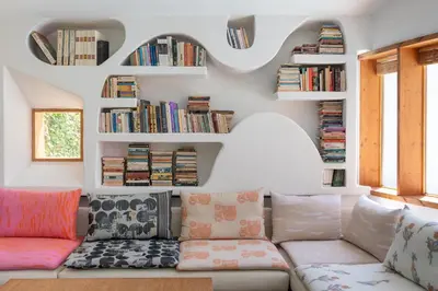a living room with a couch and bookshelves at Villa Ixia in Ialyssos