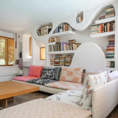 a living room with a couch and bookshelves at Villa Ixia in Ialyssos