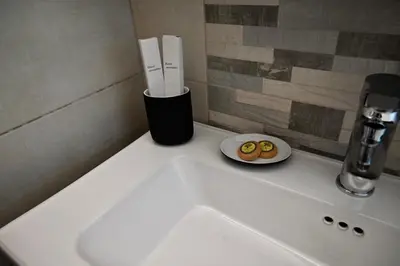 a bathroom sink with a plate of donuts on it at Casa Sym Faliraki in Faliraki