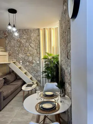 a living room with a table and a couch at Casa Sym Faliraki in Faliraki