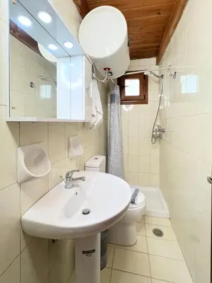 a bathroom with a sink and a toilet at Ambela House Soroni in Soroni