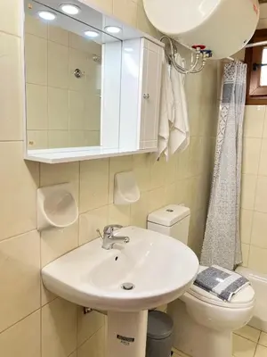a bathroom with a sink and a toilet at Ambela House Soroni in Soroni