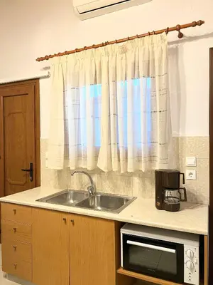 a kitchen with a sink and a window at Ambela House Soroni in Soroni