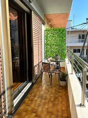 a balcony with a table and a chair at Sunset apartment in Rhodes Town