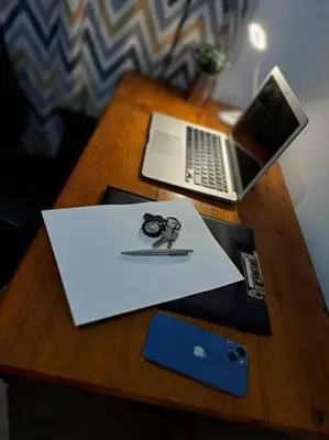 a wooden table with a laptop and a pair of scissors at Lydia's cozy house in Paradeísion