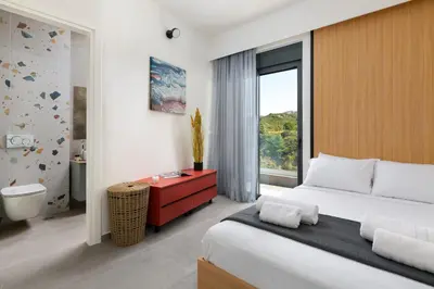 a bedroom with a large bed and a large window at Villa Korali in Pastida