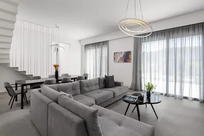 a living room with a couch and a table at Villa Korali in Pastida