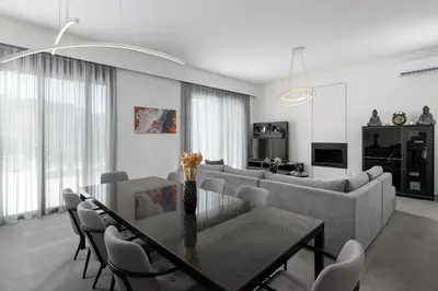 a living room with a table and a couch at Villa Korali in Pastida
