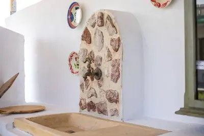 a sink in a kitchen with a stone wall at Petrino Eco Conscious Living in Kalithies