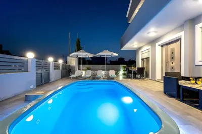 a swimming pool on the roof of a house at Villa Marina in Ialyssos