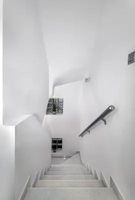 a staircase in a white building with a railing at Villa Marina in Ialyssos