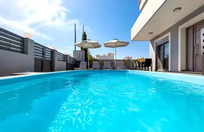a swimming pool on the roof of a house at Villa Marina in Ialyssos