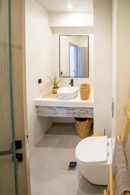 a bathroom with a sink and a toilet and a mirror at Hacienda tradition&relax in Afantou