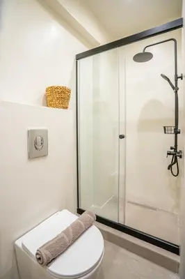 a bathroom with a toilet and a glass shower at Hacienda tradition&relax in Afantou