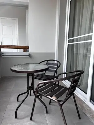 a table and two chairs sitting next to a table and a window at Hacienda tradition&relax in Afantou
