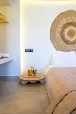 a bedroom with a bed and a table next to a bed at Hacienda tradition&relax in Afantou