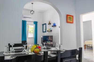 a dining room with a table with chairs and a dining roomiasm at (Stoa escape) traditional home in Archangelos